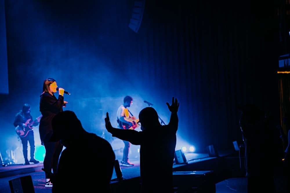 silhouette of people standing on stage