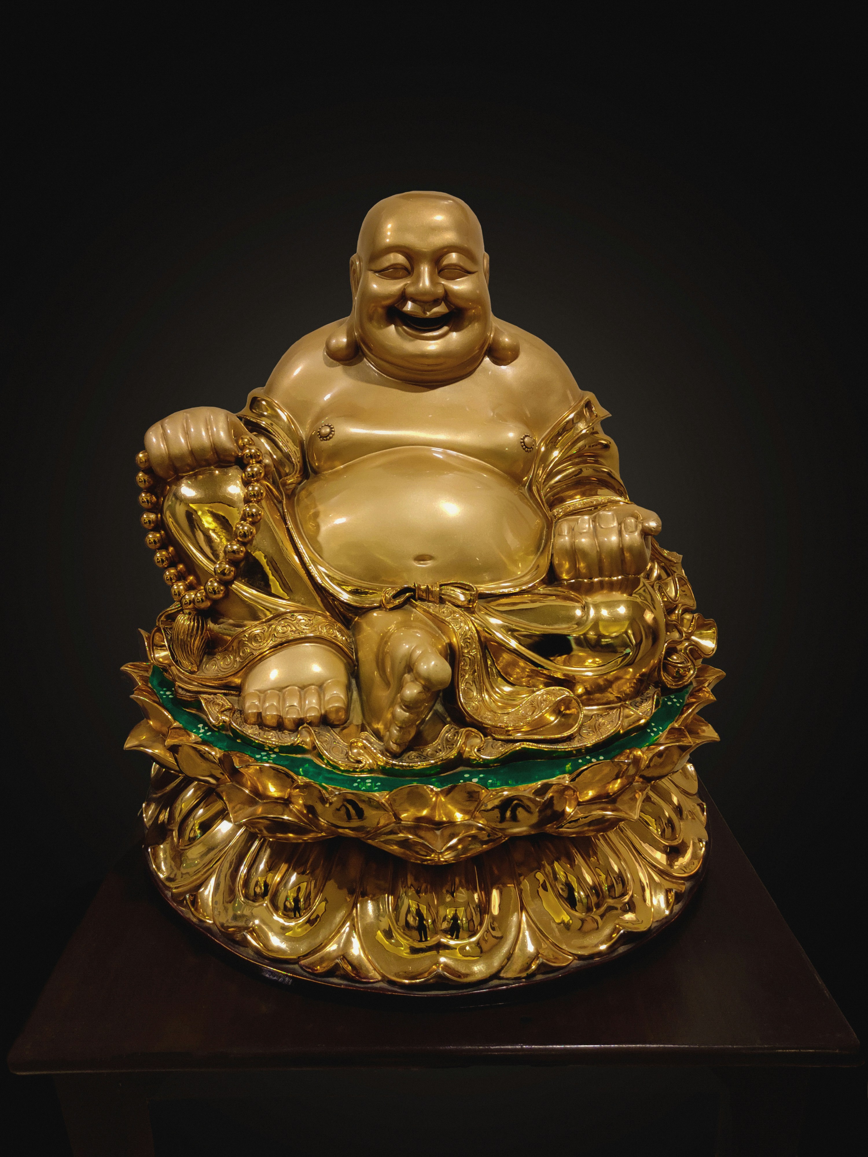 gold buddha figurine on black surface