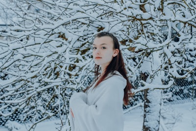 woman in white long sleeve shirt standing near white tree elves google meet background