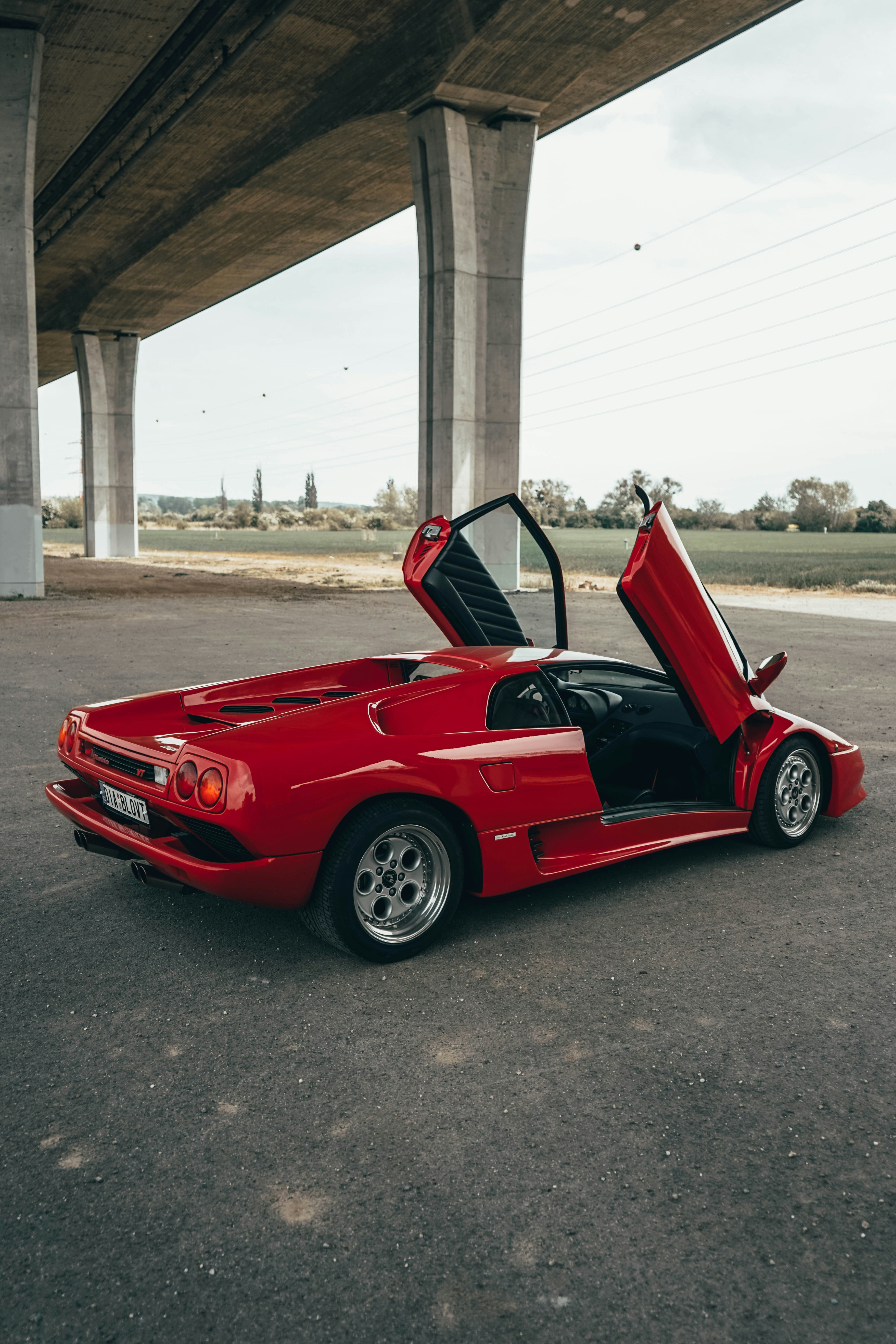 red ferrari 458 italia parked on gray asphalt road during daytime