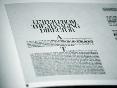 An editor reviewing a business report with notes on style and tone adjustments.
