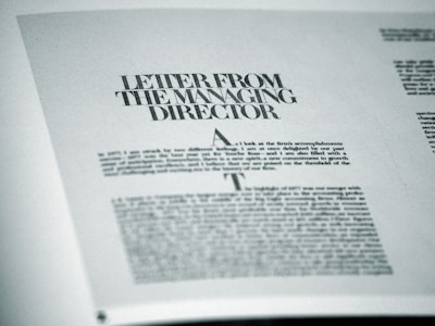 A printed page featuring a letter titled 'Letter from the Managing Director' with smaller text below. The page is angled slightly and appears to be from a formal publication, possibly a business report or brochure.