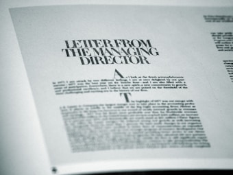 A printed page featuring a letter titled 'Letter from the Managing Director' with smaller text below. The page is angled slightly and appears to be from a formal publication, possibly a business report or brochure.