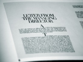 A printed page featuring a letter titled 'Letter from the Managing Director' with smaller text below. The page is angled slightly and appears to be from a formal publication, possibly a business report or brochure.