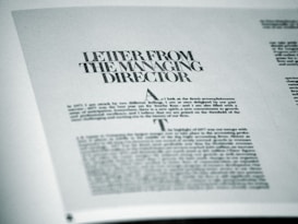 A printed page featuring a letter titled 'Letter from the Managing Director' with smaller text below. The page is angled slightly and appears to be from a formal publication, possibly a business report or brochure.
