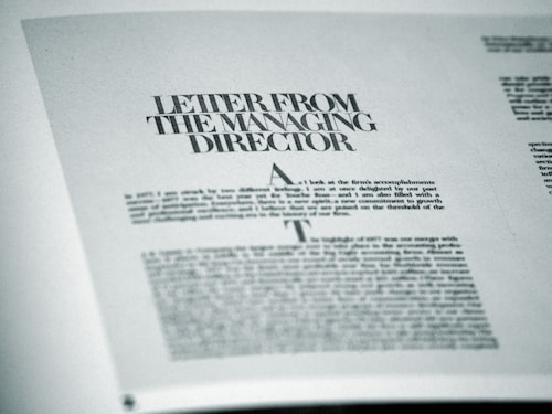 A printed page featuring a letter titled 'Letter from the Managing Director' with smaller text below. The page is angled slightly and appears to be from a formal publication, possibly a business report or brochure.