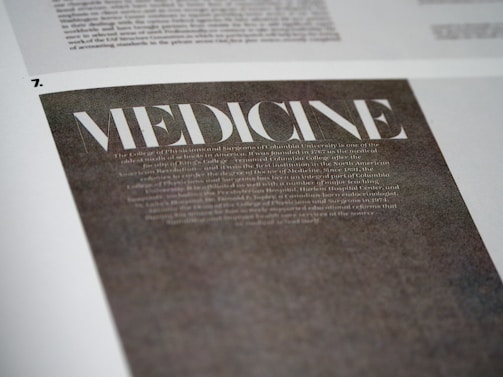 A close-up view of a page with the word 'MEDICINE' prominently displayed in large, bold, white letters on a dark background. Below it, there is smaller, less legible text that appears to be descriptive or informative in nature. The page is part of a larger document or publication.