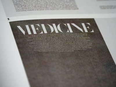 A close-up view of a page with the word 'MEDICINE' prominently displayed in large, bold, white letters on a dark background. Below it, there is smaller, less legible text that appears to be descriptive or informative in nature. The page is part of a larger document or publication.