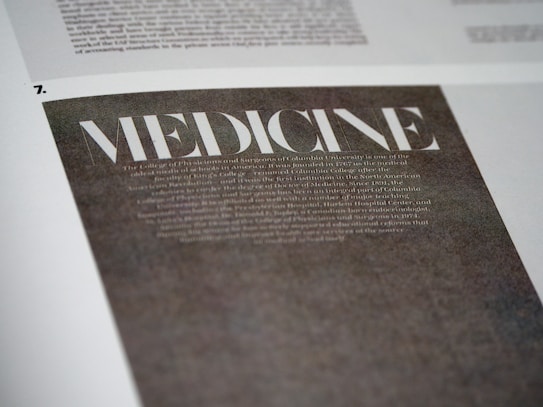 A close-up view of a page with the word 'MEDICINE' prominently displayed in large, bold, white letters on a dark background. Below it, there is smaller, less legible text that appears to be descriptive or informative in nature. The page is part of a larger document or publication.