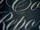 Elegant branding presentation with soft gold accents on a dark background.