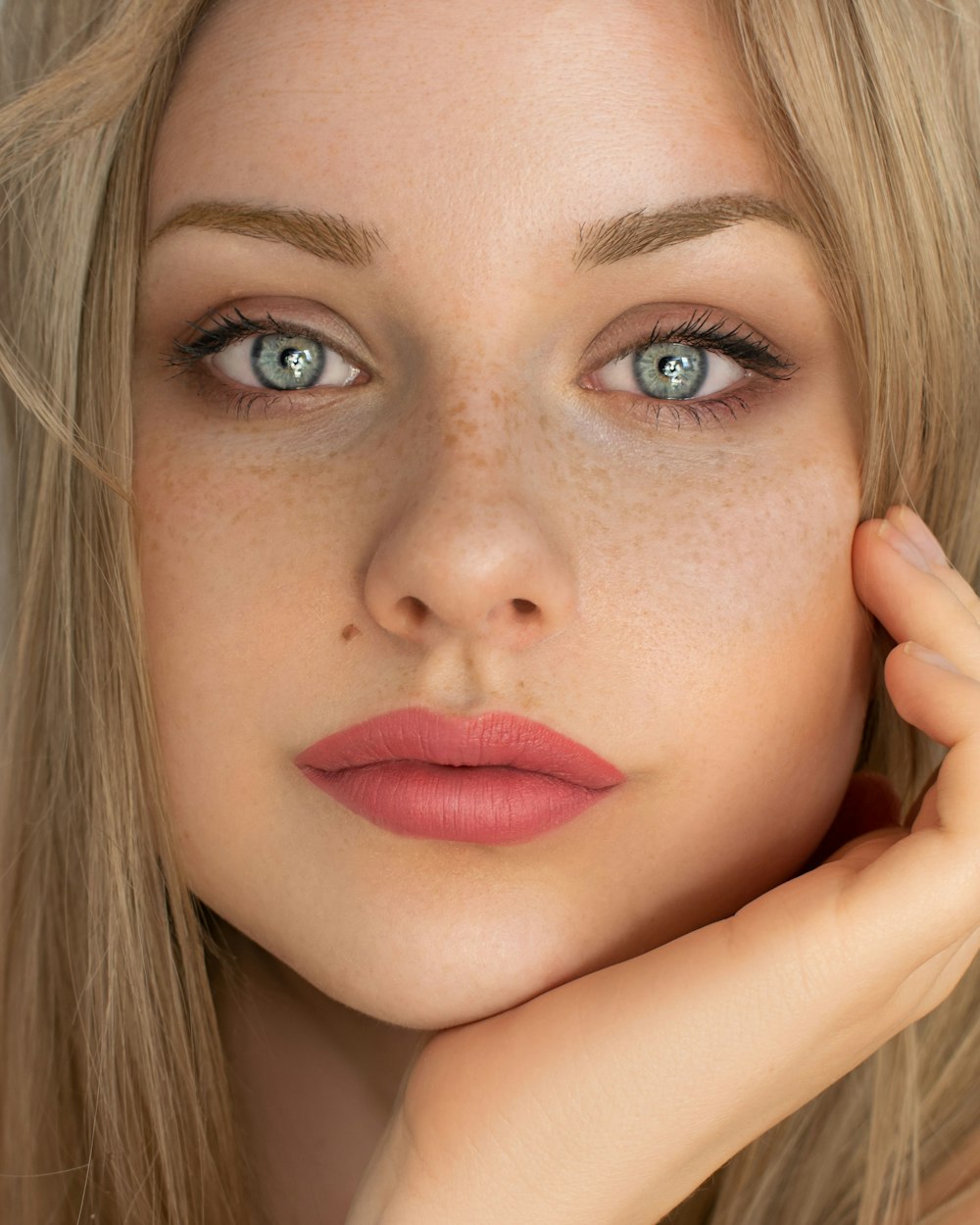 woman with red lipstick and black mascara