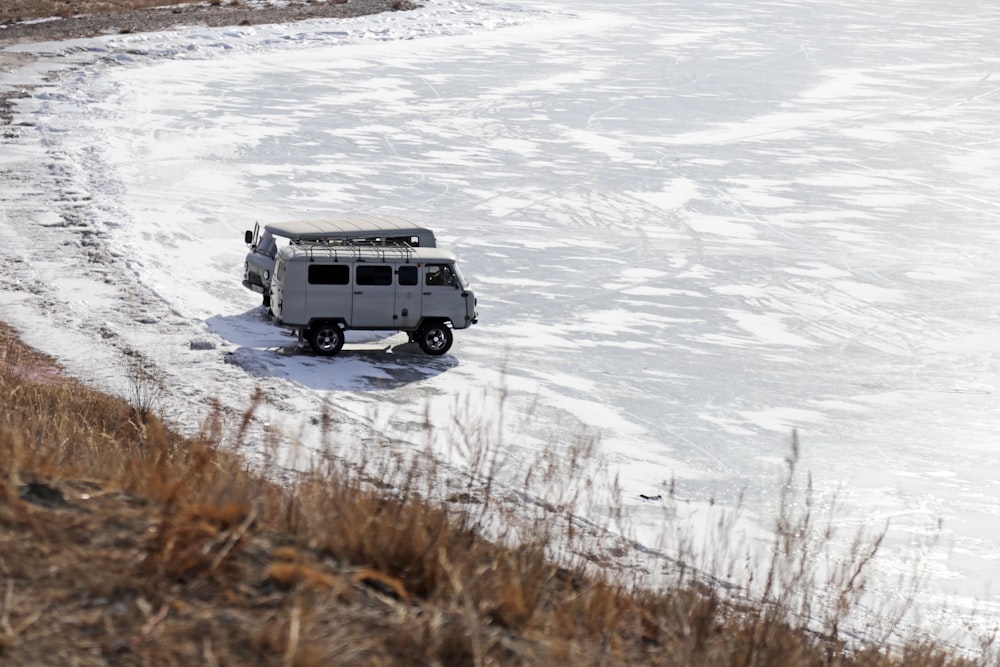 white suv on snow covered ground during daytime