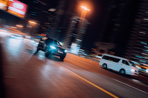 A dynamic street racing scene featuring sleek cars and powerful motorbikes on a vibrant urban backdrop.