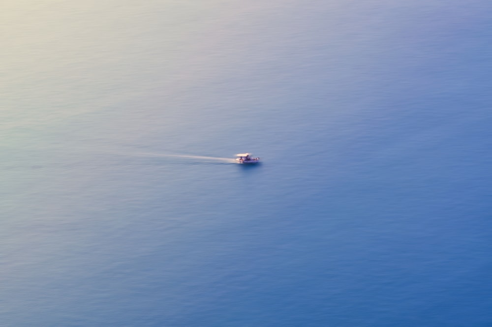 white boat on body of water during daytime