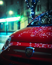 Close-up of a sleek car window with neon green tinted film reflecting city lights at dusk.