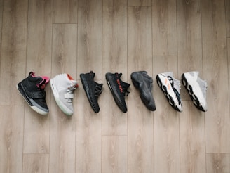 A collection of vibrant sports shoes on a wooden floor.