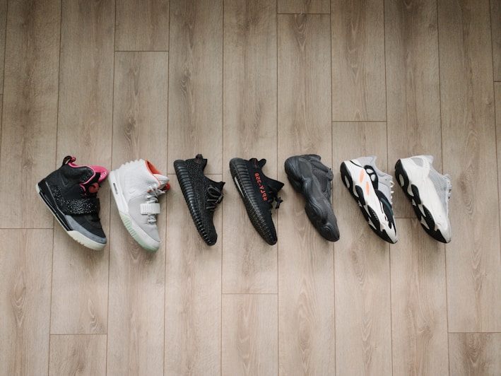 A collection of lightweight sports shoes displayed on a wooden surface.