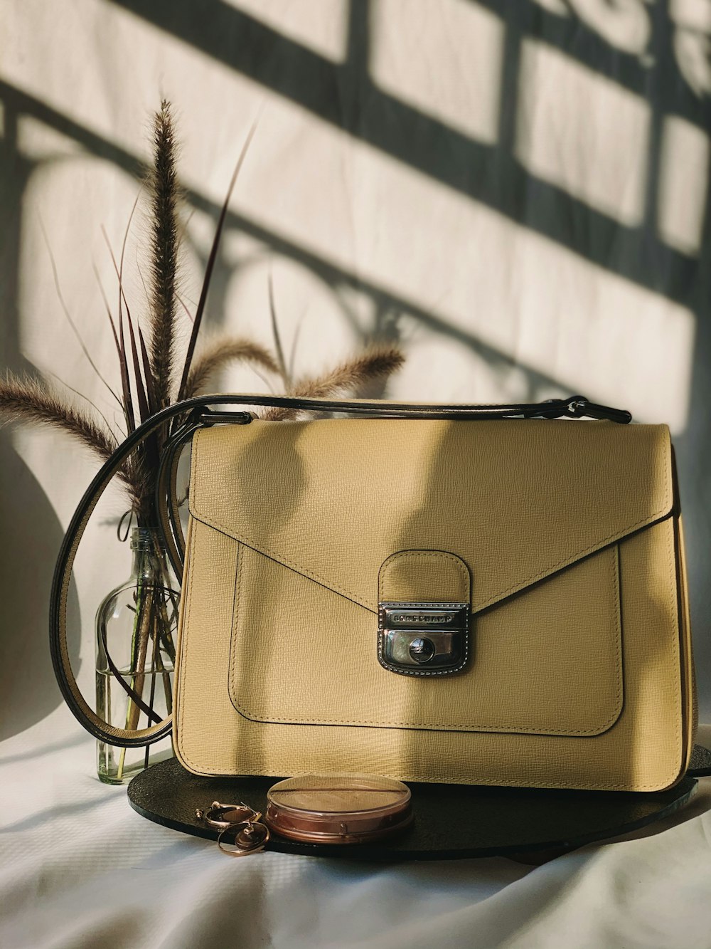 brown leather handbag on white table