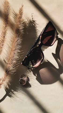 black framed sunglasses on white and black textile