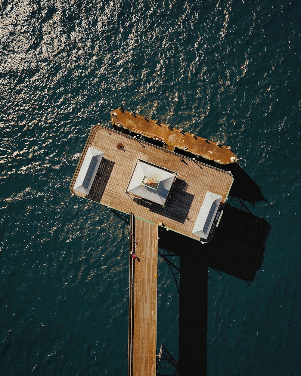 white and brown wooden house on body of water during daytime