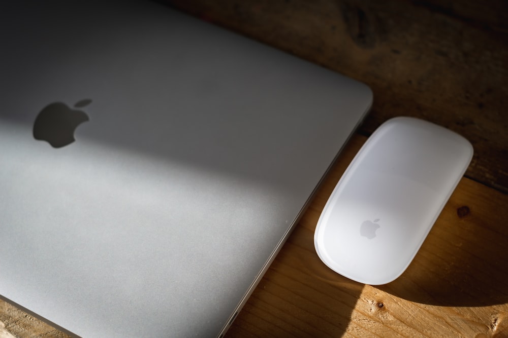 apple magic mouse on brown wooden table