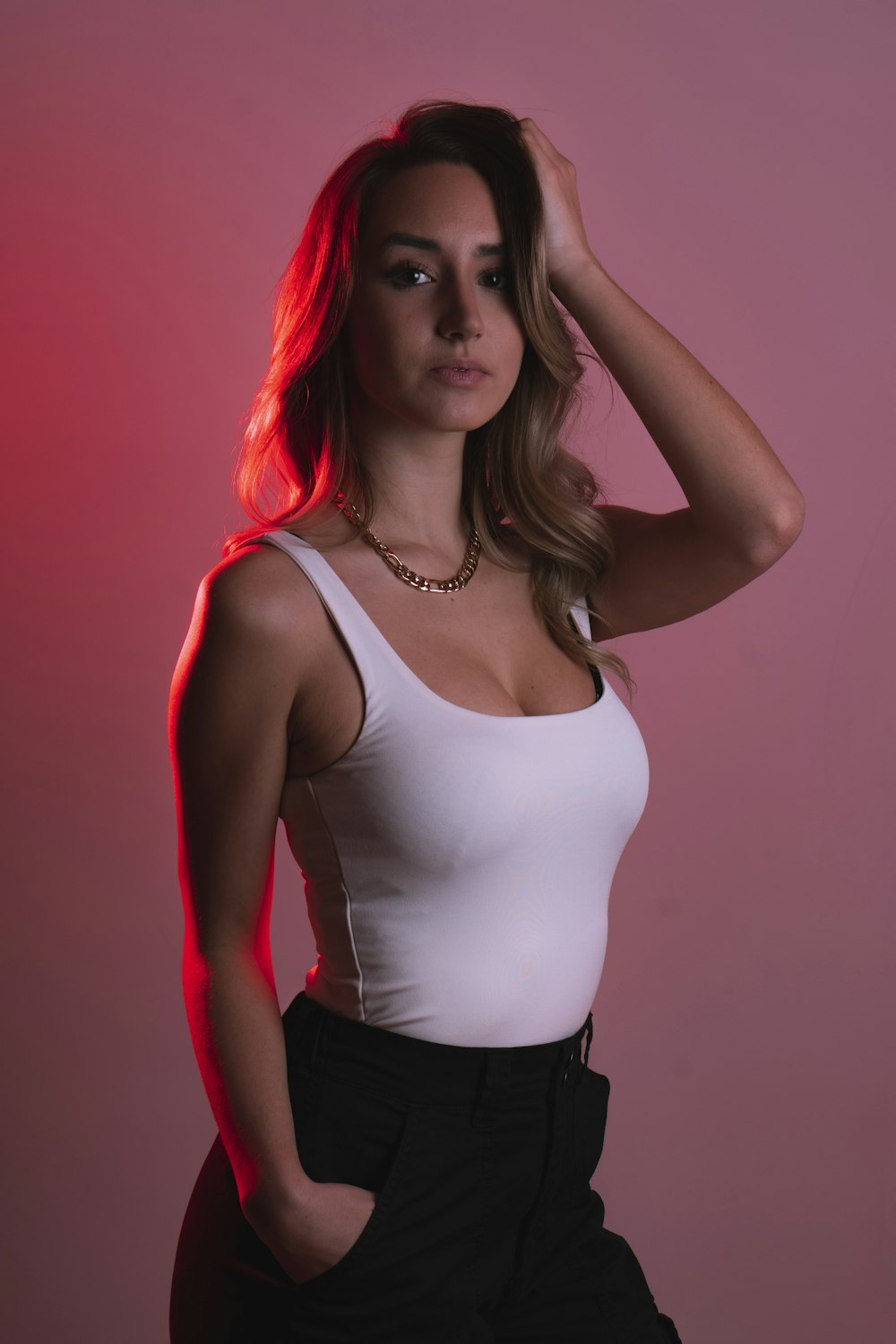 woman in white tank top and black pants