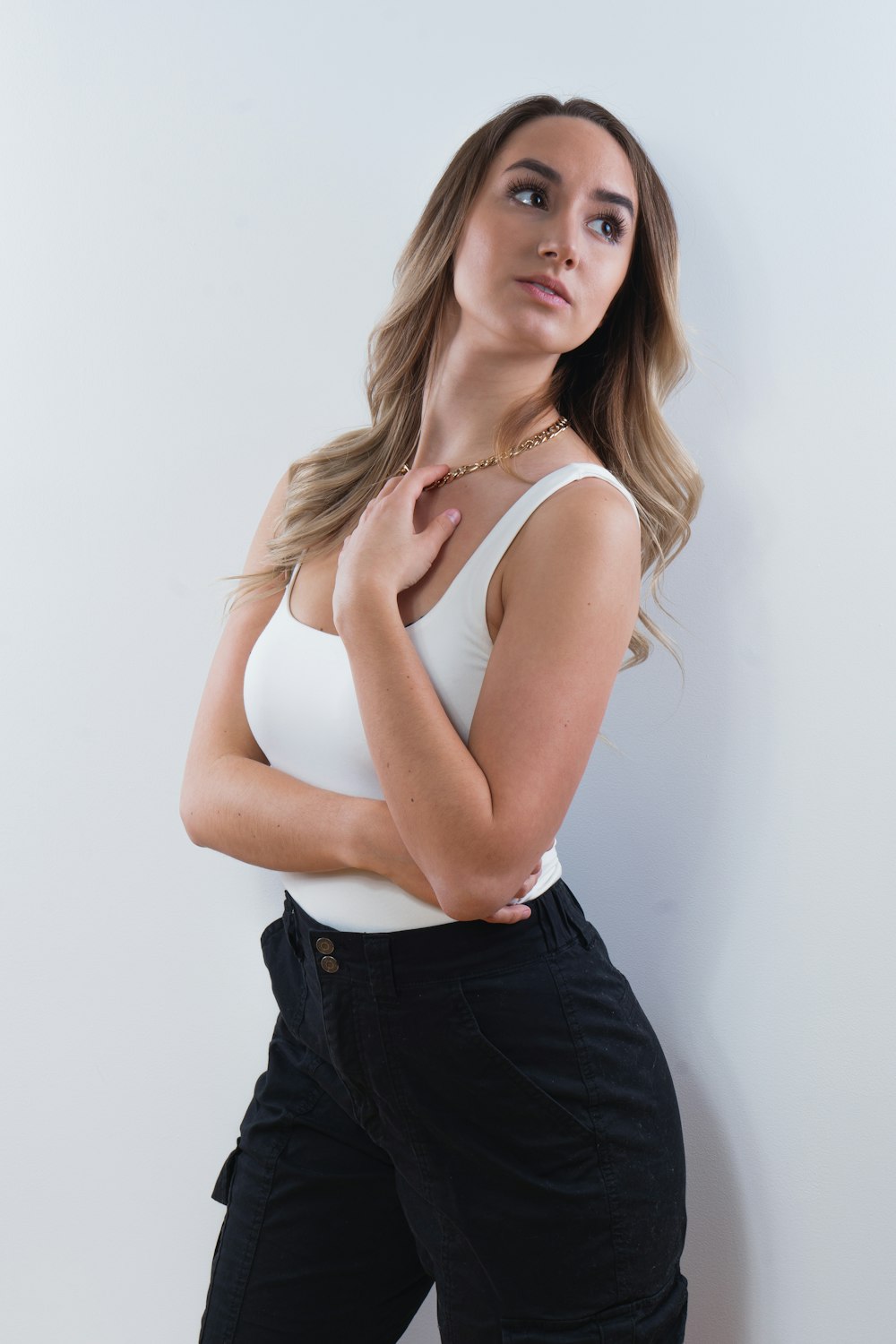 woman in white tank top and blue denim bottoms