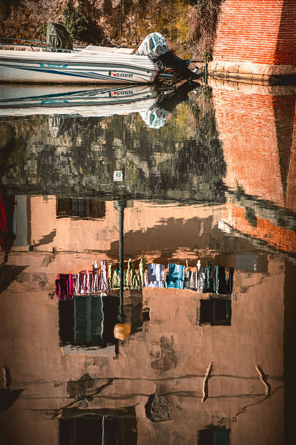 clothes hanged on string near brown brick wall