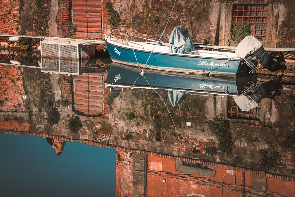 blue and white boat on water