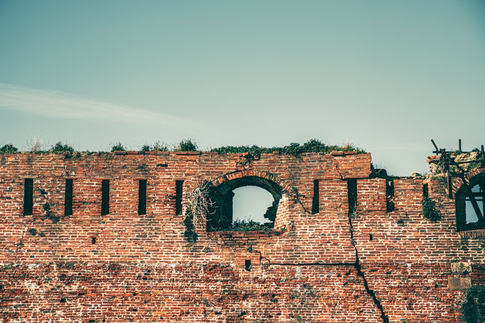 brown brick building under white sky during daytime