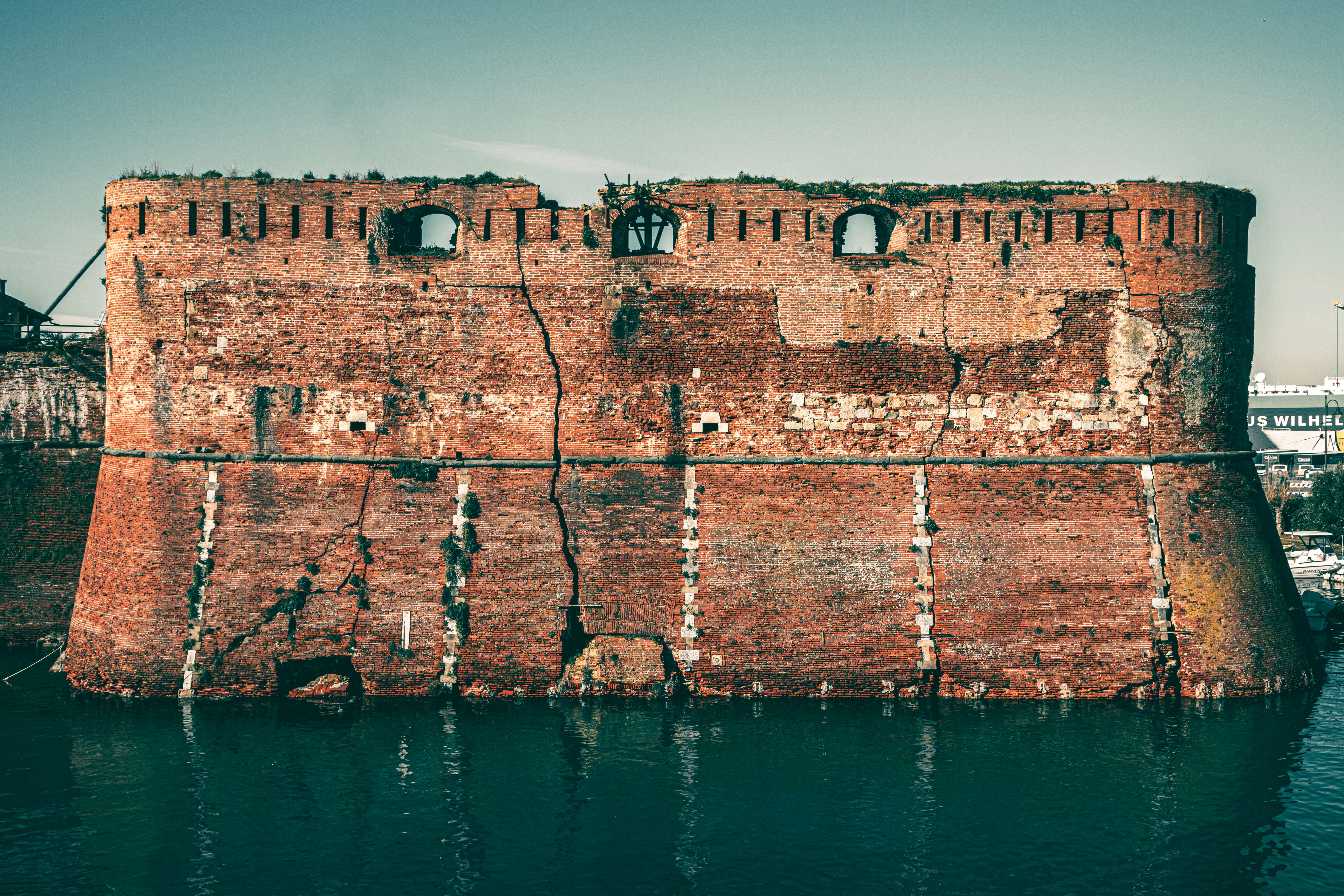 brown concrete building near body of water during daytime