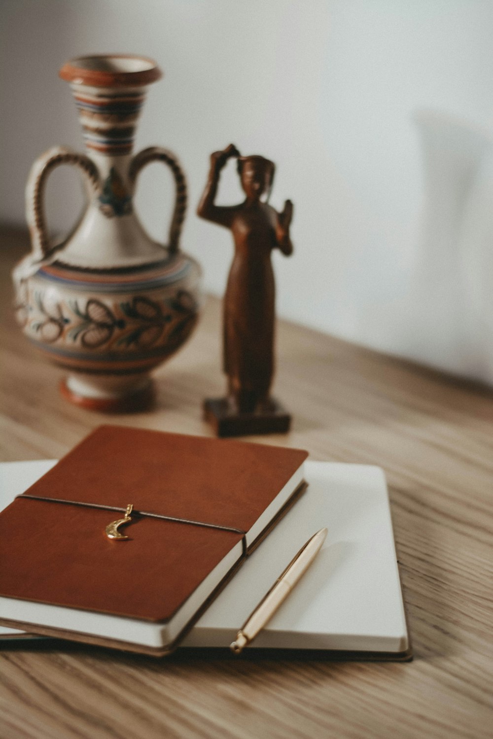 gold and silver pen on brown wooden table