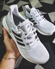 A close-up of lightweight running sneakers on a track, showcasing their breathable material and sleek design.