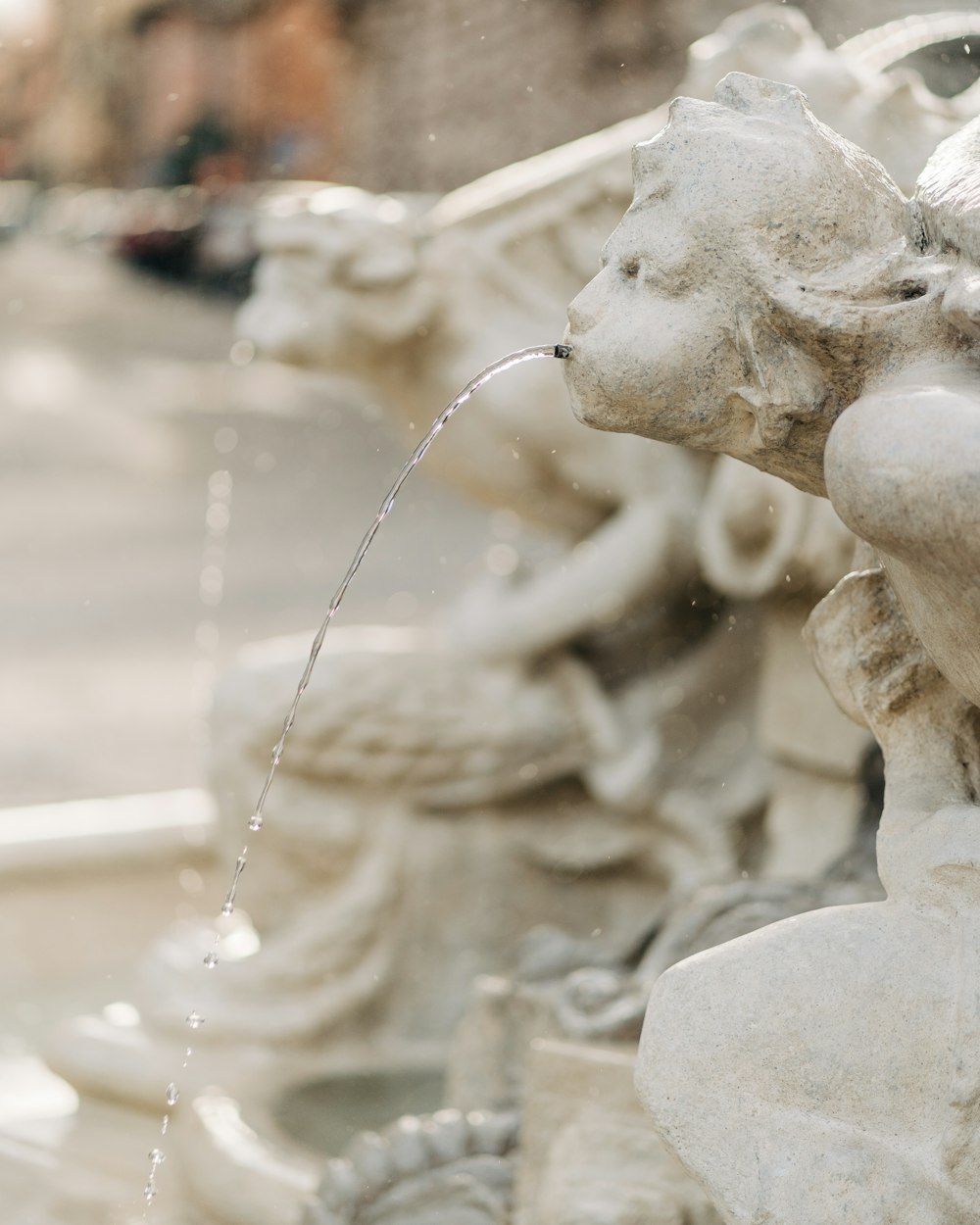 white concrete statue of woman