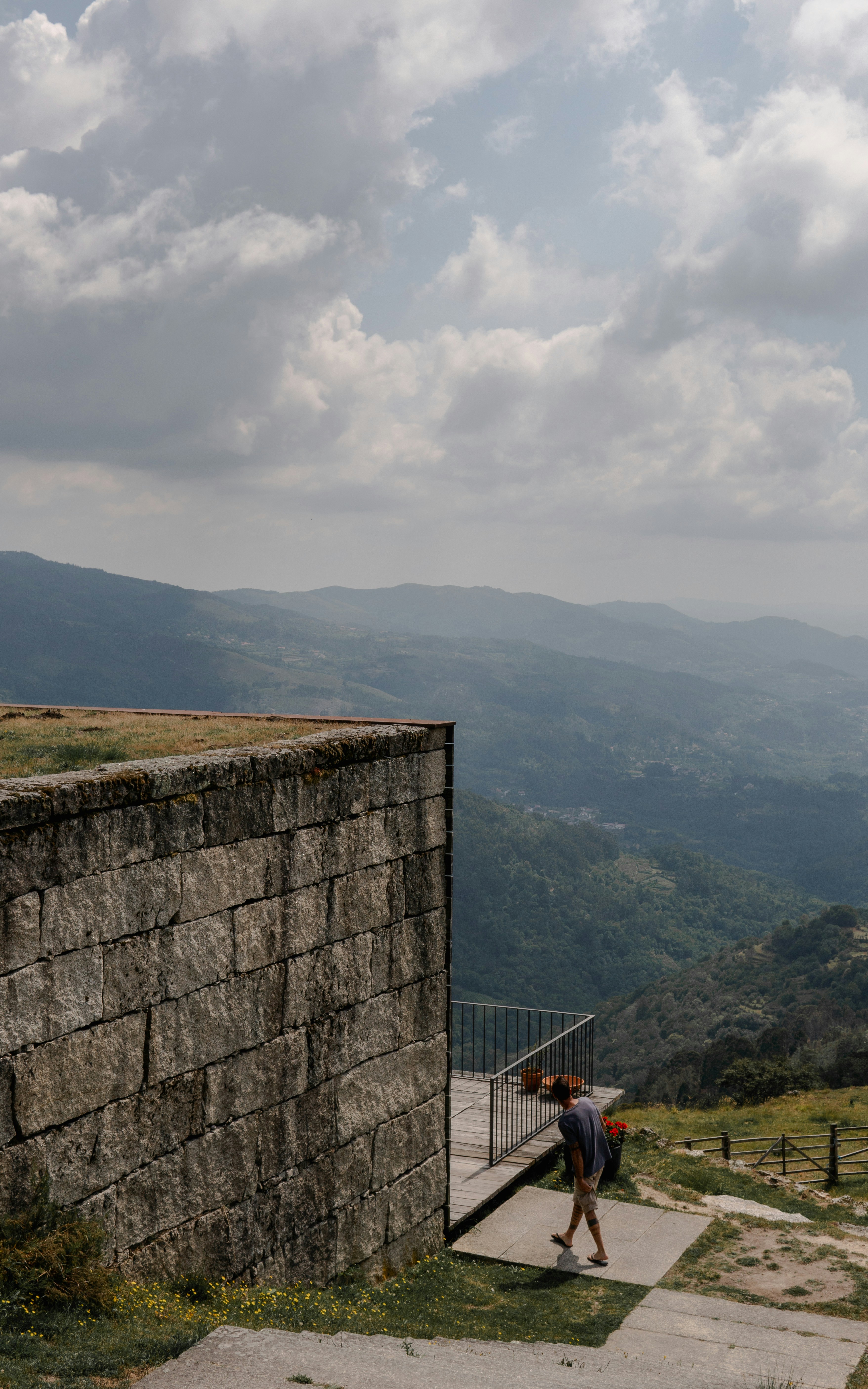 gray concrete wall near mountain during daytime