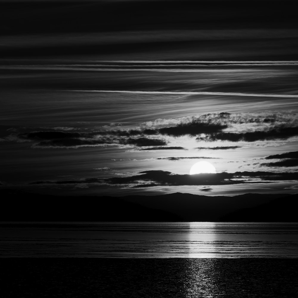 body of water under cloudy sky during daytime