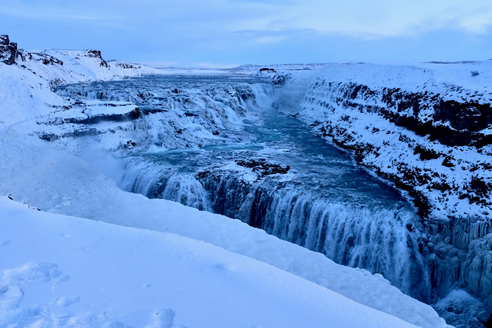 water falls under white sky during daytime