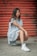 woman in white dress sitting on concrete floor
