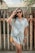 woman in white and blue stripe button up shirt wearing black sunglasses