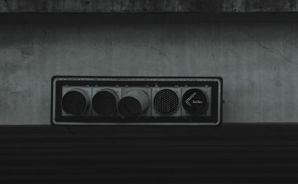 black and white speaker on gray concrete wall