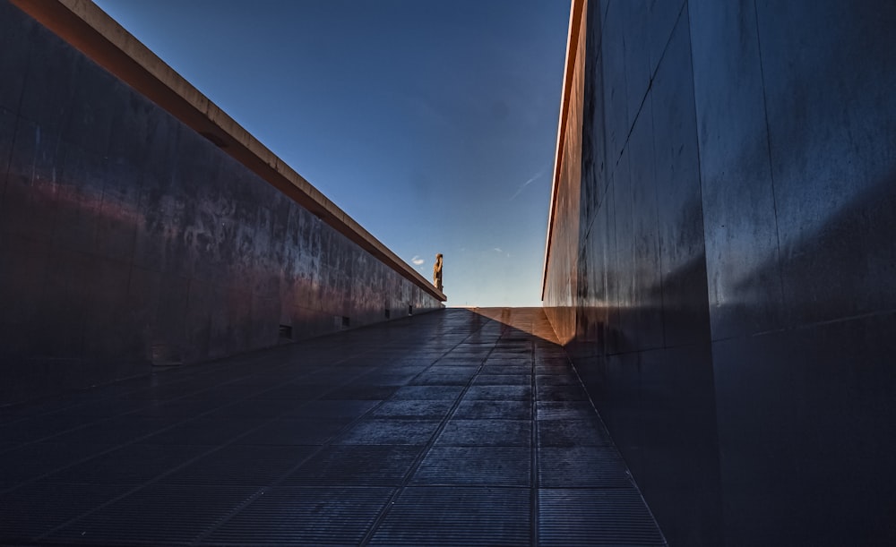 person walking on gray concrete pathway during daytime