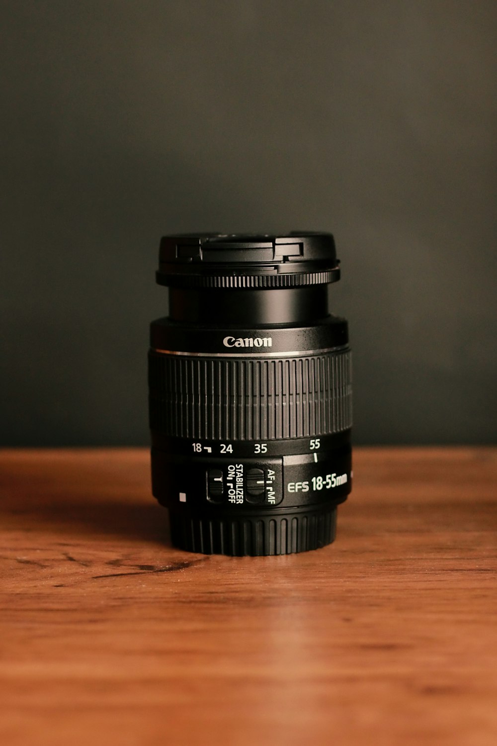 black camera lens on brown wooden table