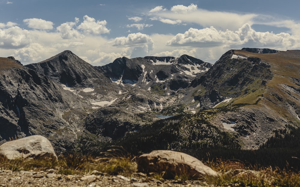 black and white mountains under white clouds and blue sky during daytime