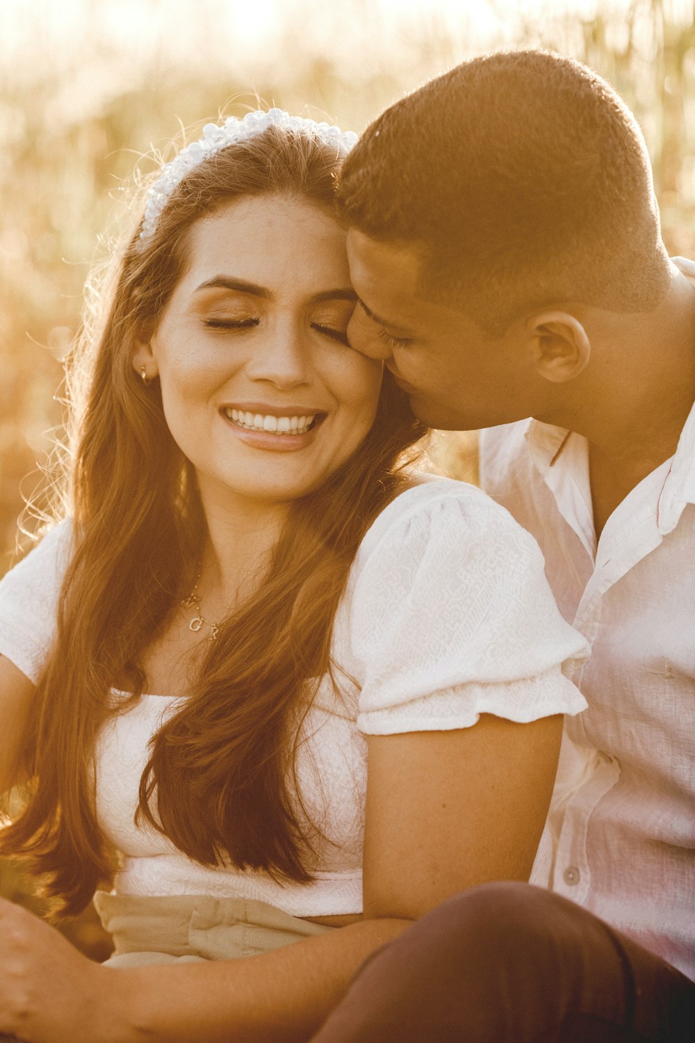 smiling woman in white dress shirt beside smiling man in white dress shirt