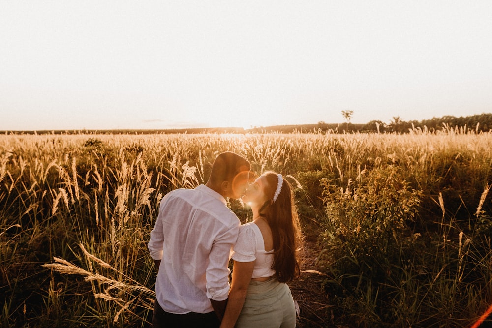 man and woman standing on brown grass field during daytime