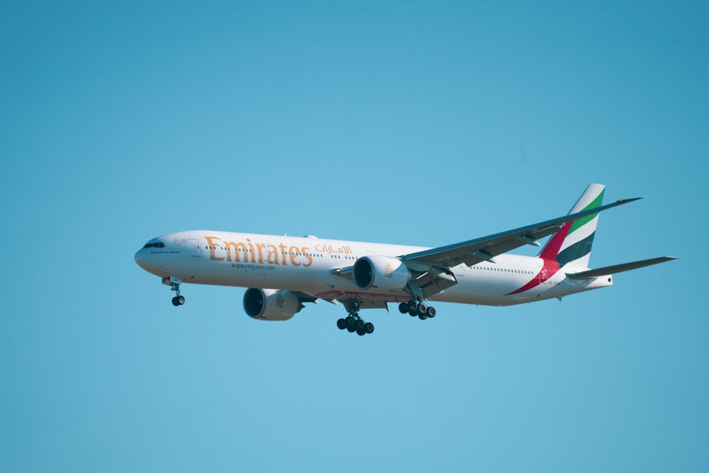 white and red passenger plane in the sky