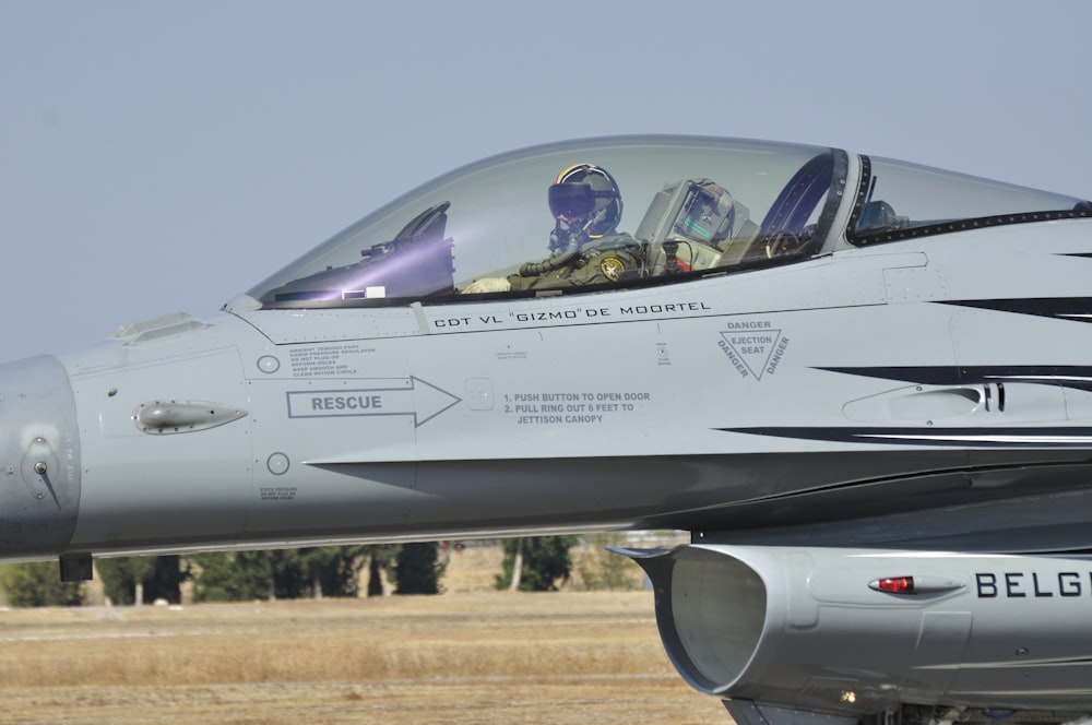 gray fighter jet on brown field during daytime