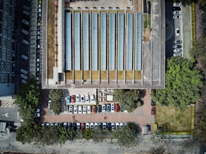 A sleek solar canopy shading a busy mall parking lot with EV chargers.