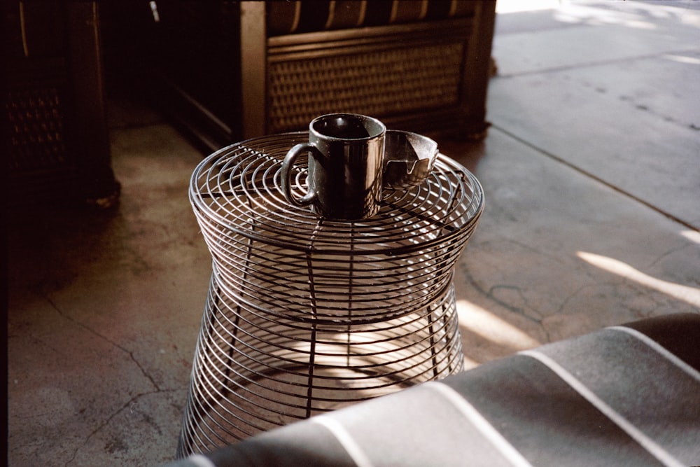 stainless steel cup on brown woven basket
