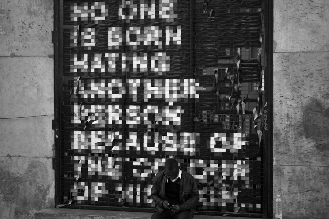 man in black jacket standing in front of building